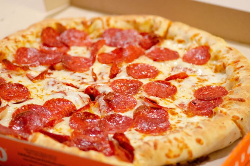 Close up of pepperoni pizza in take out box